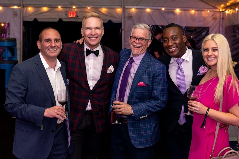 Five friends pose for a photo at a wine festival