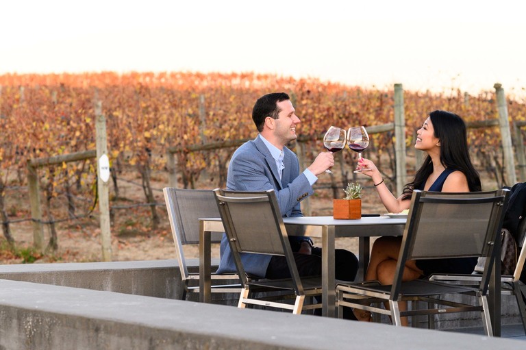 A couple toasts on a patio