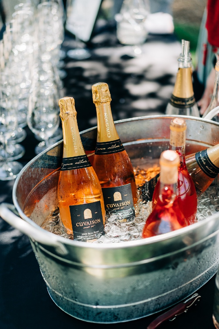 Bottles of Rose wine chill in a bucket
