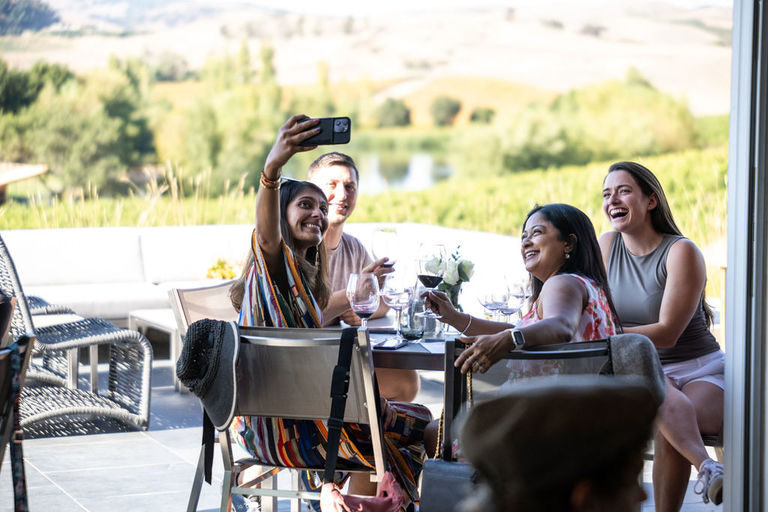 Four friends take a selfie on a winery patio