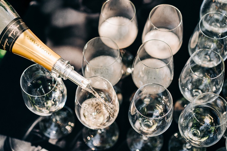 Sparkling wine fills wine glasses