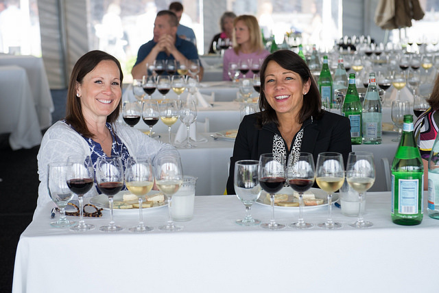 Two women enjoying a food and wine tasting.