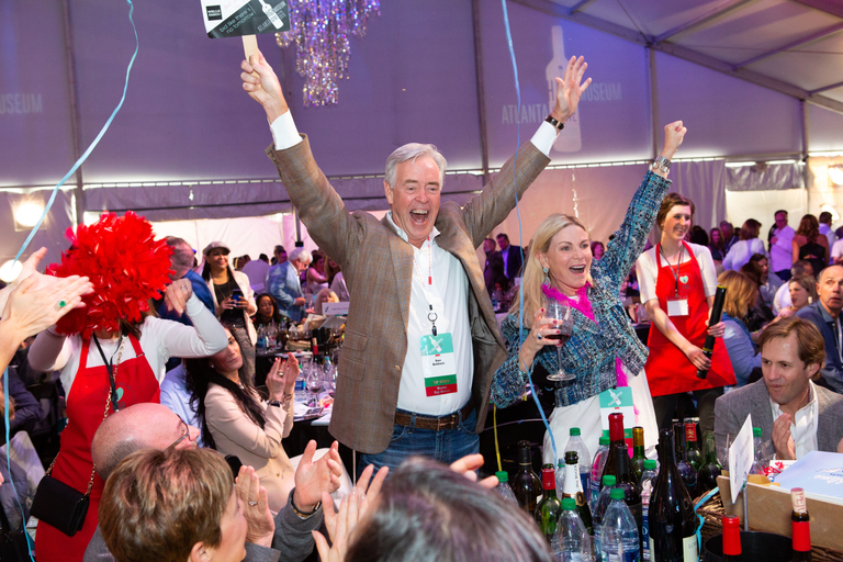 Image from High Museum Atlanta of happy auction guest celebrating